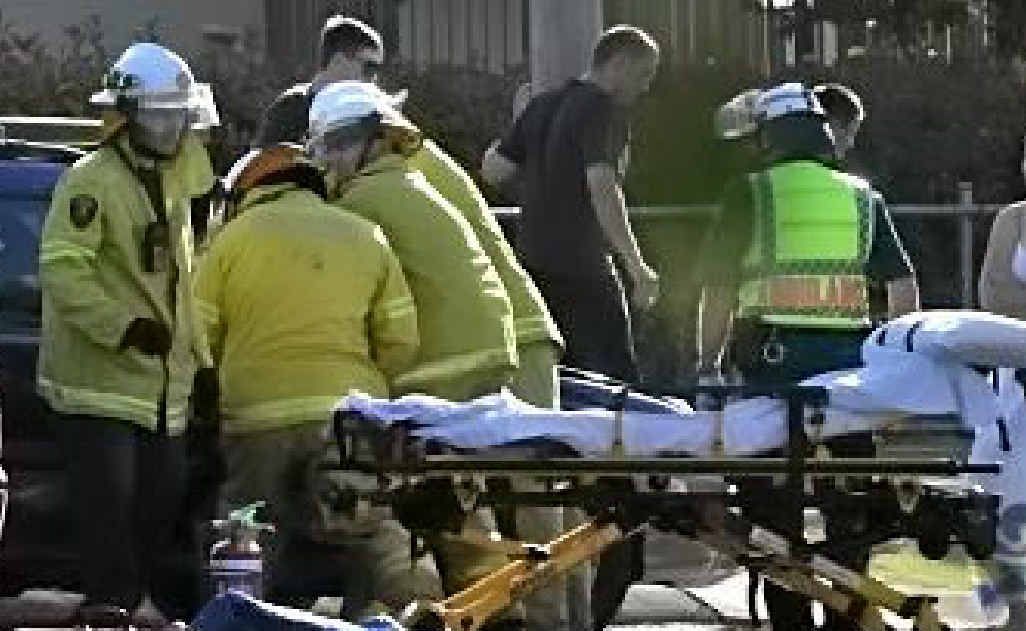 Fire crews work to free a trapped driver in a two-vehicle crash yesterday afternoon.